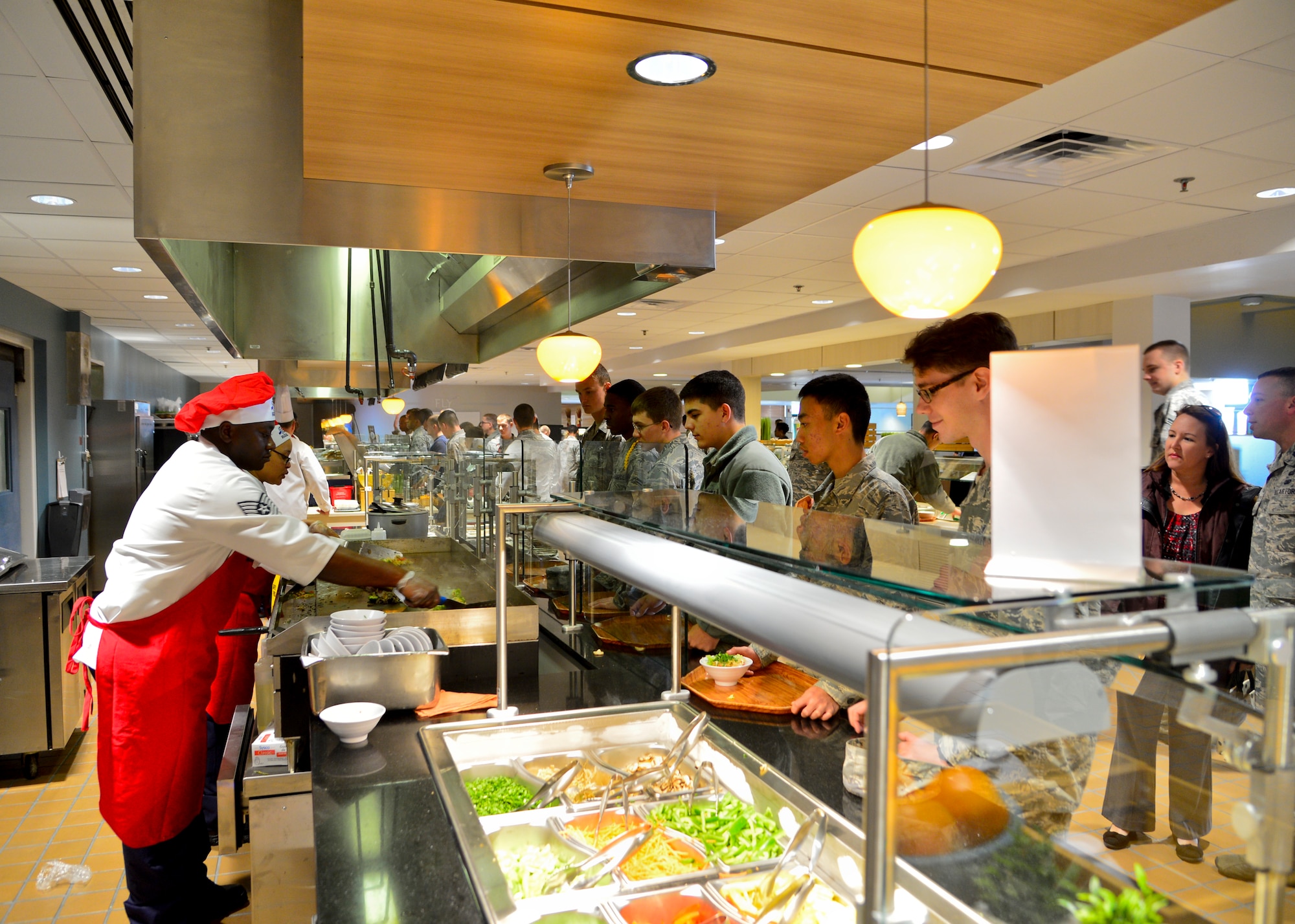Tech. Sgt. Mark Obeng Duro, 436th Force Support Squadron food service section chief, and Staff Sgt. Jessica Williams, 436th FSS food service supervisor, operate the new Mongolian grill during the soft opening of the Patterson Dining Facility Nov. 17, 2015, at Dover Air Force Base, Del. The dining facility closed earlier this year to undergo improvements from the Air Force Food Transformation Initiative and now offers more, healthier options for dining customers. (U.S. Air Force photo/Senior Airman William Johnson)