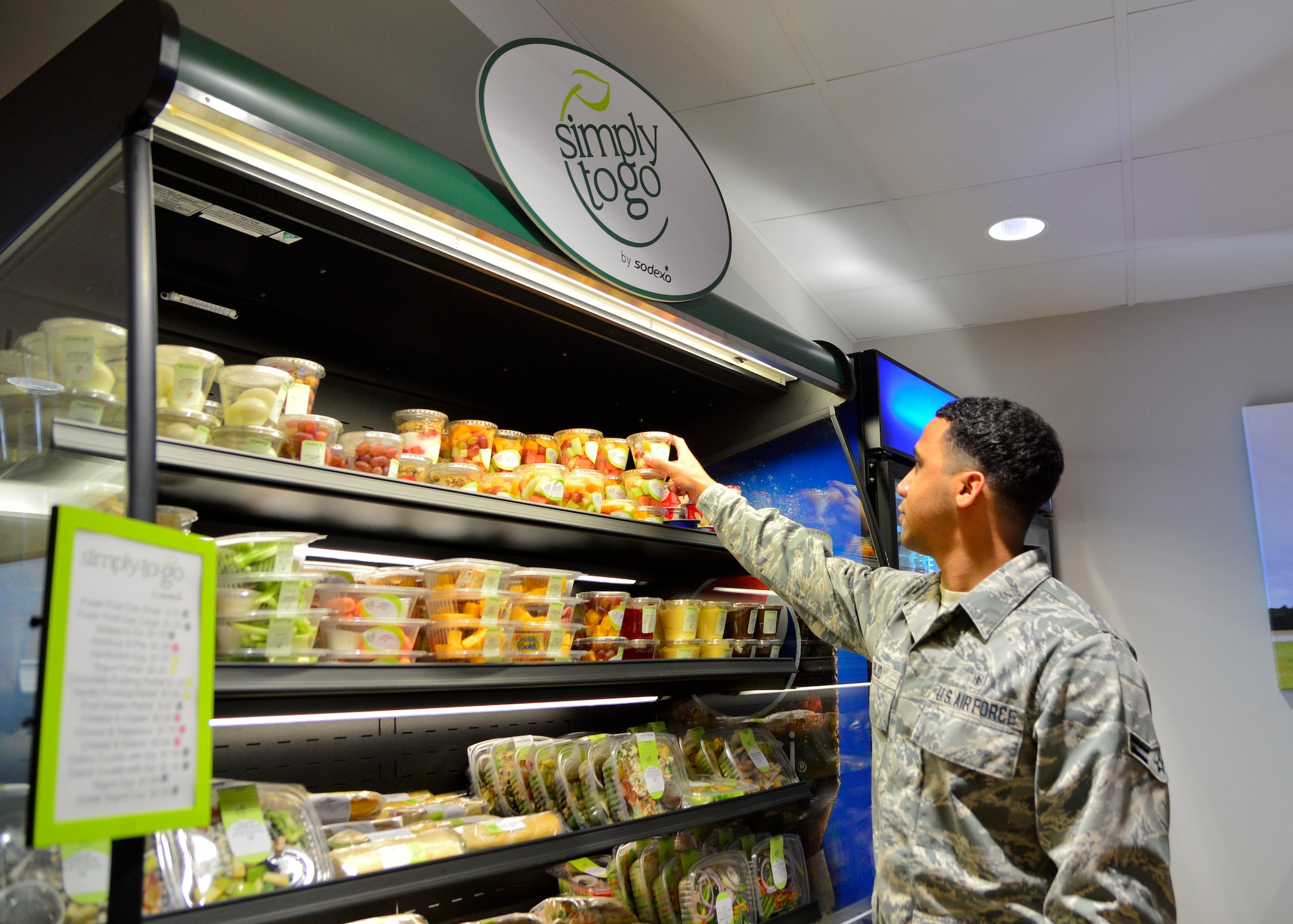 Airman 1st Class Jorge Rijo, 436th Aerospace Medicine Squadron bioenvironmental engineer, grabs a to-go fruit cup during the soft opening of the Patterson Dining Facility Nov. 17, 2015, at Dover Air Force Base, Del. The dining facility now offers grab-n-go items outside of normal operating hours. (U.S. Air Force photo/Senior Airman William Johnson)