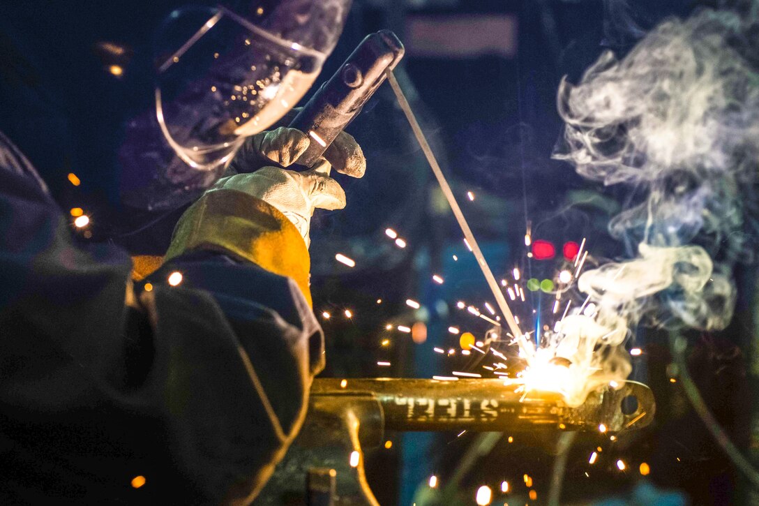 U.S. Navy Seaman Monica Huerta welds a brace bar using a stick welder aboard the USS Ronald Reagan at sea, Nov. 18, 2015. The Ronald Reagan and its embarked air wing, Carrier Air Wing 5, provide a combat-ready force to protect and defend the maritime interests of the U.S. and its allies and partners in the Indo-Asia-Pacific region. U.S. Navy photo by Petty Officer 3rd Class Ryan McFarlane