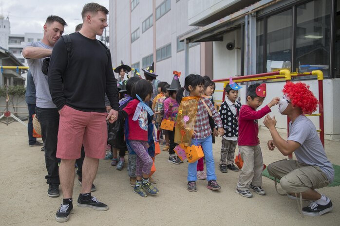 Service members stationed at Marine Corps Air Station Iwakuni, Japan, paired up with Japanese children from the Ekimae Hoikuen Pre-school before walking around town in Iwakuni City, Oct. 27, 2015. The community relations event, hosted by the Marine Memorial Chapel on the air station, gave service members the opportunity to interact with the Japanese youth and teach them about Halloween. Service members are afforded an opportunity to explore Iwakuni and experience the Japanese culture by volunteering for these events.