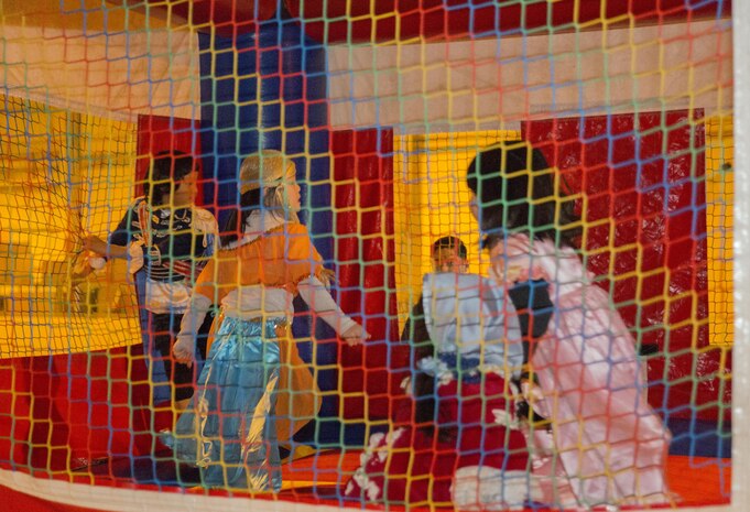 Orphans from Garden of Light Children’s Home in Hatsukaichi, Hiroshima Prefecture, Japan, play in a bounce castle at Marine Corps Air Station Iwakuni, Oct. 31, 2015. During their visit, 50 station volunteers escorted 15 orphans to a haunted house operated by Marines from Marine Wing Support Squadron 171, enjoyed bonding over dinner and trick-or-treating around the air station. This event allowed the orphans to experience the American culture and tradition by partaking in one of our holidays.