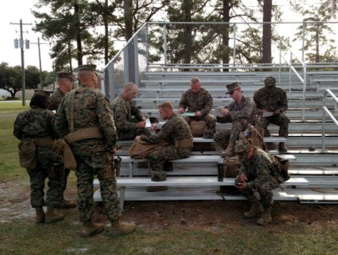 17 Nov 2015 - Sgt Keith, RSU Combat Marksmanship Coach (center, top) reviews data books with his firing detail in preparation for qualification day.