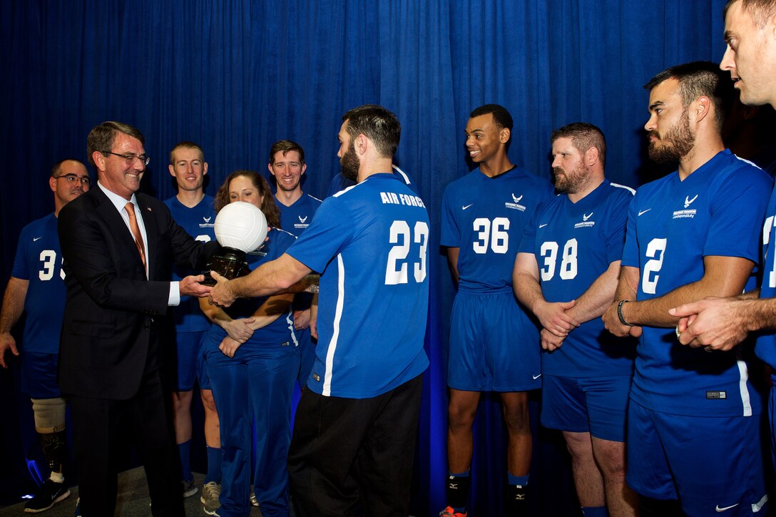 Defense Secretary Ash Carter presents the trophy to Team Air Force at the Warrior Care Month Sitting Volleyball Tournament at the Pentagon, Nov. 19, 2015. DoD photo by Casper Manlangit