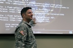 Louisiana National Guards Lt. Col. Henry T. Capello, chief communications officer, conducting training for the Cyber Defense Incident Response Team (CDIRT). To practice looking for potential security breaches during training, members of the Louisiana Army and Air National Guard who are on the CDIRT log onto computers  formatted to duplicate common operating systems and website platforms and look for unusual activity that may indicate that a hacker is actively compromising a state website. 