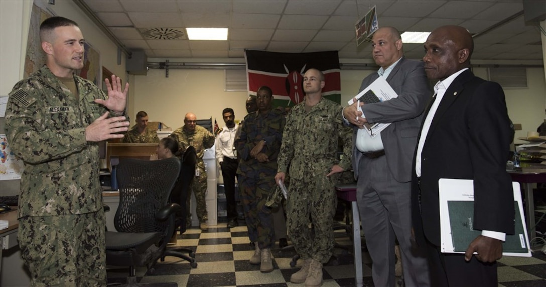 Ambassador Issimail Chanfi, director of the Eastern Africa Standby Force, receives an introduction to the Fusion Action Cell at Camp Lemonnier, Djibouti, Oct. 27, 2015. The FAC is comprised of service members from the U.S., Europe and East Africa working together to setup military-to-military projects and civilian support initiatives in partner countries throughout the Horn of Africa. U.S. Africa Command photo