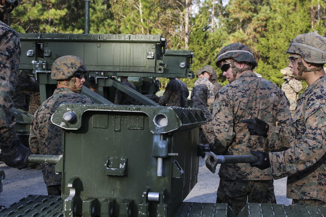 Marine students attending the 8th Engineer Support Battalion Medium Girder Bridge Master’s Course prepare to lift a bridge part during a field exercise at Camp Lejeune, N.C., Nov. 18, 2015. 8th Engineer Support Battalion has the only full-manned Bridge Company in the Marine Corps. (U.S. Marine Corps photo by Cpl. Paul S. Martinez/Released)