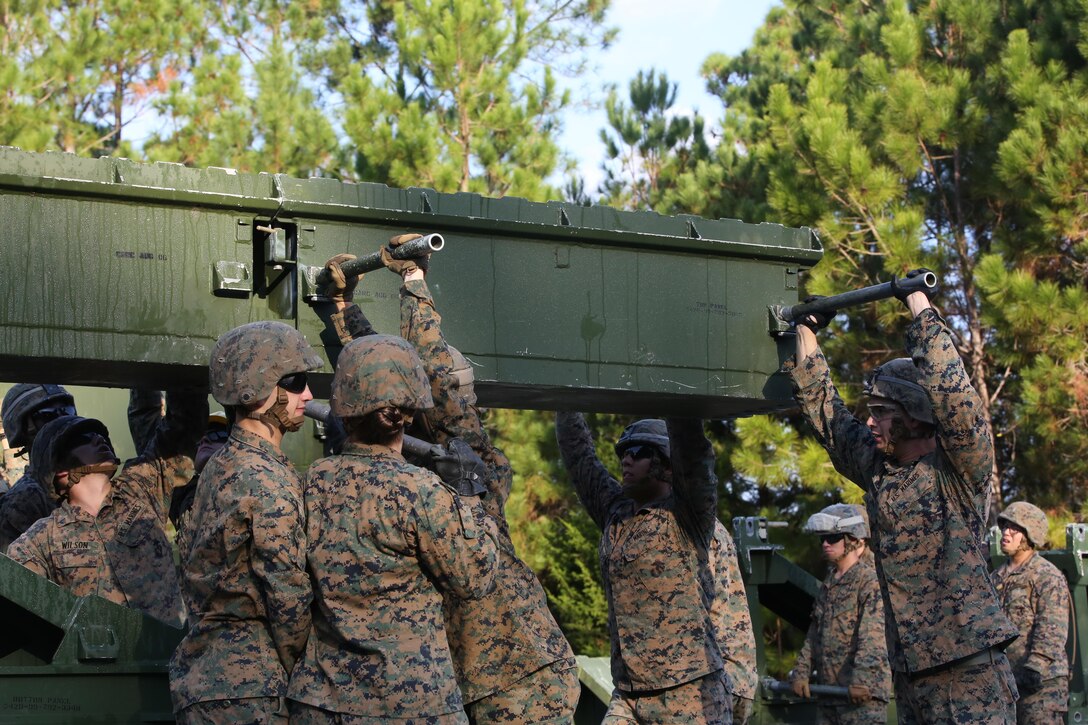 Marine students attending the 8th Engineer Support Battalion Medium Girder Bridge Master’s Course prepare to lift a bridge part during a field exercise at Camp Lejeune, N.C., Nov. 18, 2015. 8th Engineer Support Battalion has the only full-manned Bridge Company in the Marine Corps. (U.S. Marine Corps photo by Cpl. Paul S. Martinez/Released)
