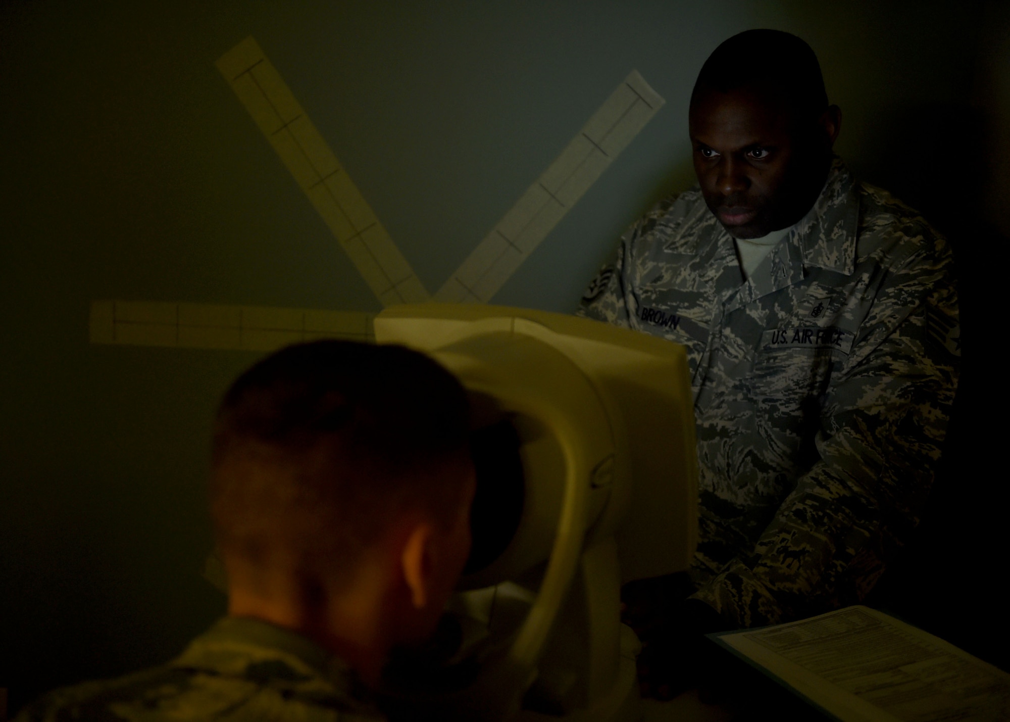 U.S. Air Force Staff Sgt. Terrence Brown Sr., 97th Medical Operations Squadron NCO in charge of optometry services performs an eye exam on a patient at the 97th Medical Group, Oct. 1, 2015 at Altus Air Force Base, Okla. The clinic screens for any type of condition within the eye, provides prescriptions and do repairs and fittings for glasses. If diagnosed, the clinic can treat some conditions on site. (U.S. Air Force photo by Airman 1st Class Megan E. Acs/Released
