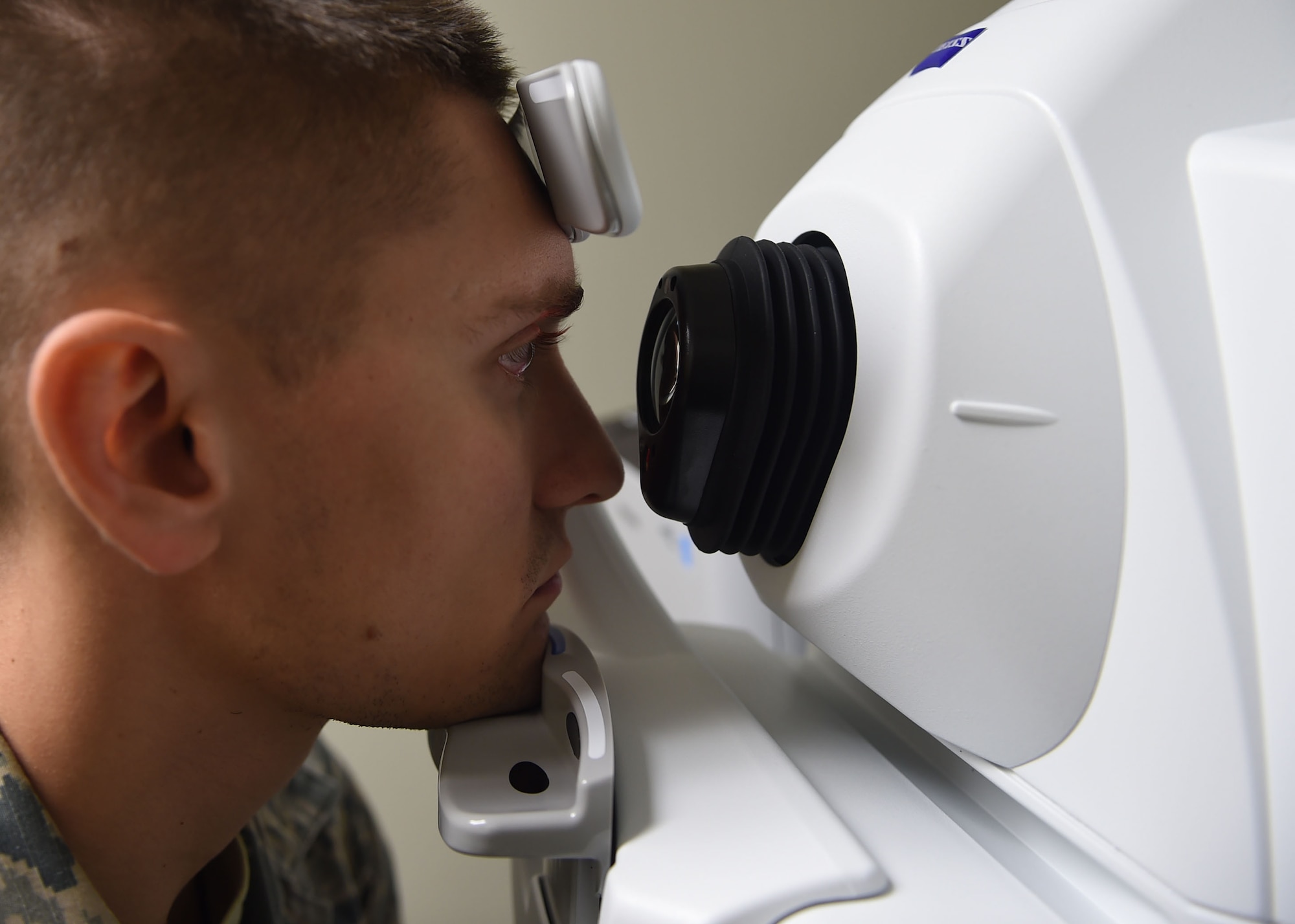 U.S. Air Force Senior Airman Stetson Montgomery, 97th Civil Engineer Squadron heating, ventilation, air conditioning and refrigeration technician, undergoes an eye exam at the 97th Medical Group, Oct. 1, 2015 at Altus Air Force Base, Okla. The clinic screens for any type of condition within the eye, provides prescriptions and do repairs and fittings for glasses. If diagnosed, the clinic can treat some conditions on site. (U.S. Air Force photo by Airman 1st Class Megan E. Acs/Released)