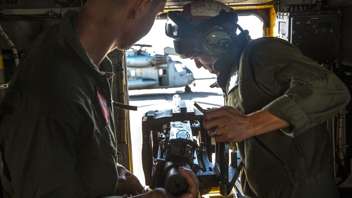 Marines with Marine Heavy Helicopter Squadron 465 “Warhorse” mount a .50-caliber machine gun onto a CH-53E Super Stallion aboard Marine Corps Air Station Miramar, California, Nov. 16. Marines with HMH-465 will conduct aerial gun shoots, fire bucket training and terrain flights over the course of five days in El Centro, California. 