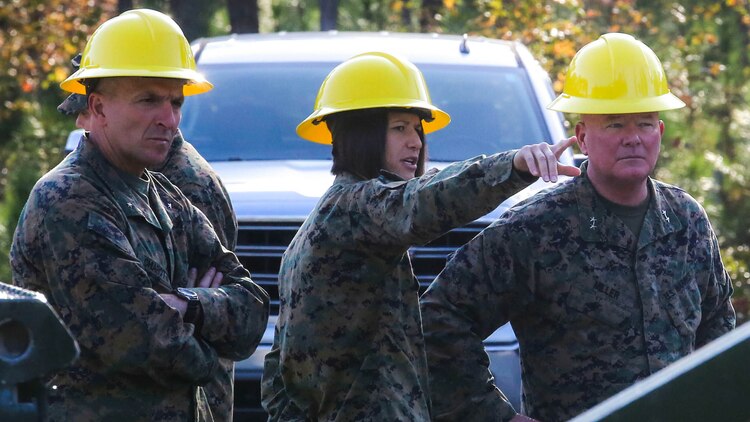 Maj. Gen. Walter L. Miller, right, commanding general, II Marine Expeditionary Force, and Brig. Gen. Charles G. Chiarotti, commanding general, 2nd Marine Logistics Group, are briefed by Capt. Ashley Christman, commanding officer of Bridge Company, 8th Engineer Support Battalion, on the 8th ESB Medium Girder Bridge Master’s at Marine Corps Base Camp Lejeune, North Carolina, Nov. 18, 2015. Miller and Chiarotti visited the training site to observe students undergoing the course. 