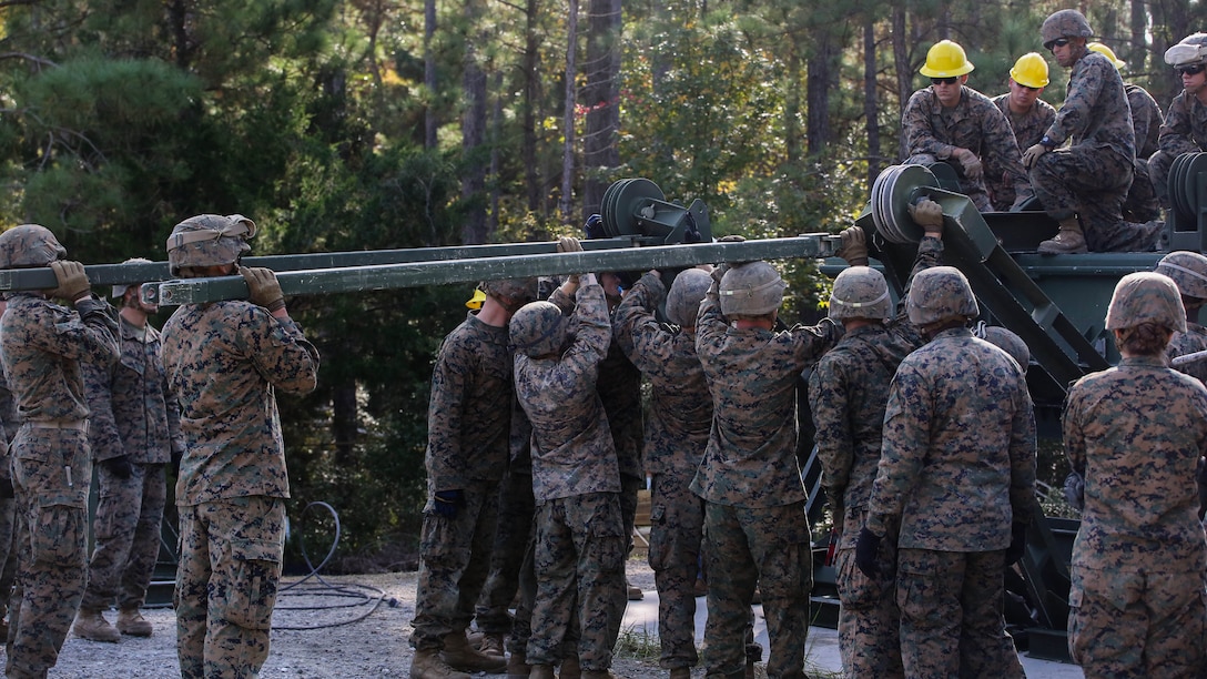 Marine students attending the 8th Engineer Support Battalion Medium Girder Bridge Master’s Course prepare the link reinforcement process during a field exercise at Marine Corps Base Camp Lejeune, North Carolina, Nov. 18, 2015. Link reinforcement requires additional bridge parts to make the bridge more stable. 