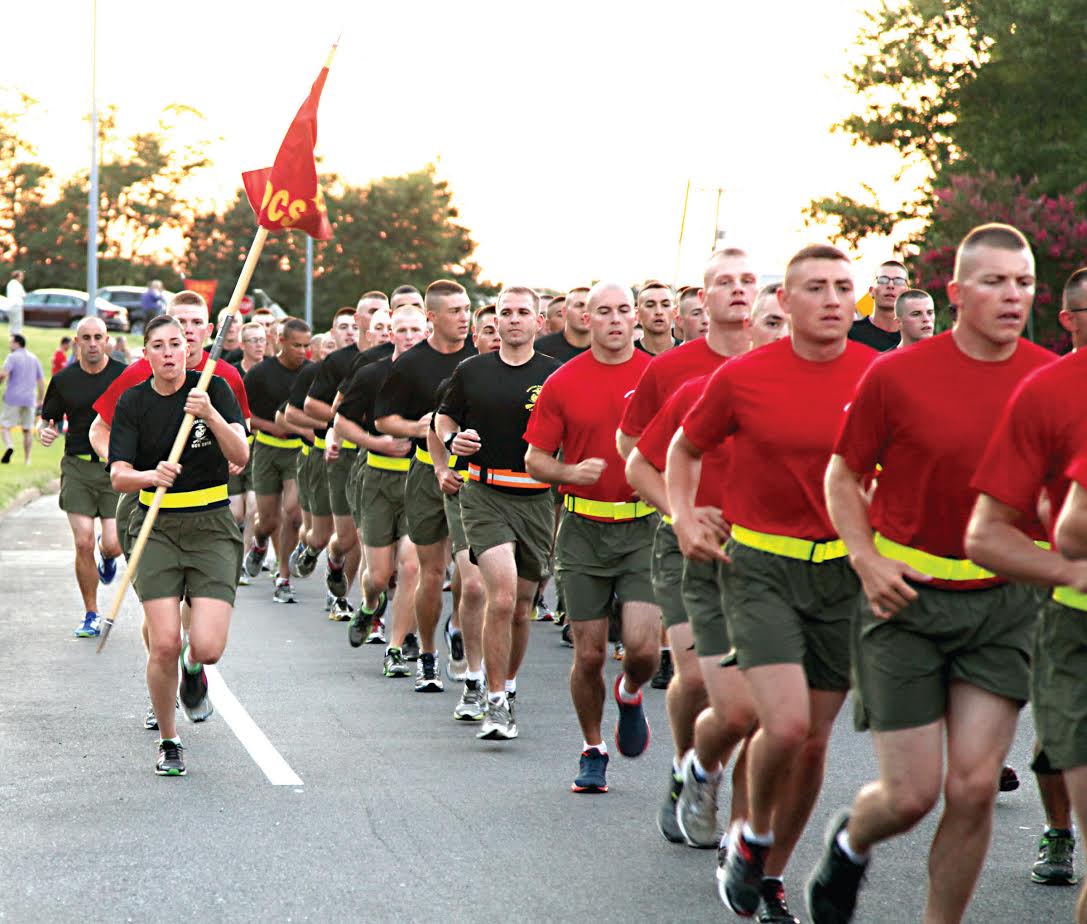 Candidates and staff of Companies L and I from the Officer Candidates School participate in a motivational run just after dawn Aug. 15, 2014 through Marine Corps Base Quantico as friends and families gathered along the route to cheer on their candidates. Family day orientation and lunch followed the run. Graduation ceremonies were held Aug. 16, 2014 on the OCS parade deck. (Photo by David M. White/released.)
