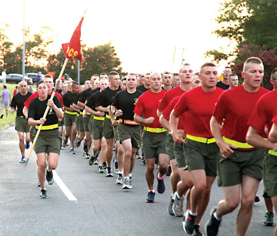 Candidates and staff of Companies L and I from the Officer Candidates School participate in a motivational run just after dawn Aug. 15, 2014 through Marine Corps Base Quantico as friends and families gathered along the route to cheer on their candidates. Family day orientation and lunch followed the run. Graduation ceremonies were held Aug. 16, 2014 on the OCS parade deck. (Photo by David M. White/released.)