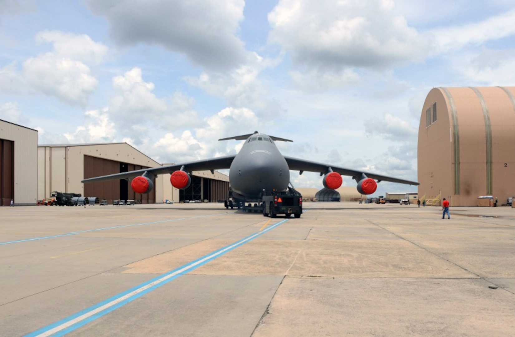 A C-5 is towed from a 559th Aircraft Maintenance Squadron repair facility at Robins Air Force Base, Georgia May 27, 2015. A strategic initiative between DLA Aviation and the Air Force Commodity Council developed cost effective measures of replacing the planes’ honeycomb panels.