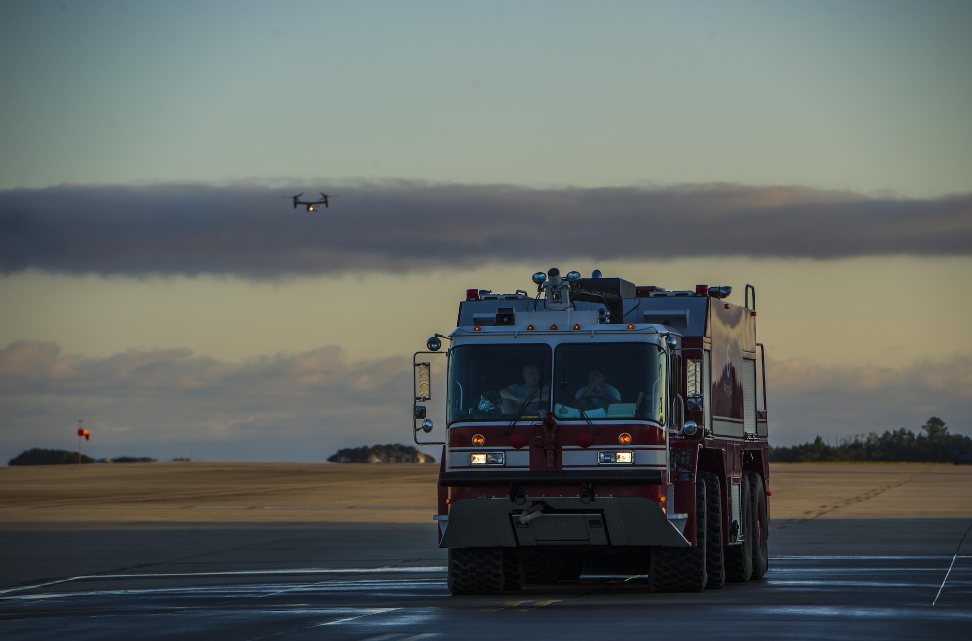 Firefighters with the 1st Special Operations Civil Engineer Squadron Fire Department wait for a CV-22B Osprey to land during Col. Ted Corallo’s “fini flight” at Hurlburt Field, Fla., Nov. 10, 2015. Corallo graduated from the U.S. Air Force Academy in 1989 and went on to undergraduate pilot training at Columbus Air Force Base, Miss. He served as the Air Force Special Operations Command chief of staff for the last 18 months. (U.S. Air Force photo by Senior Airman Christopher Callaway) 