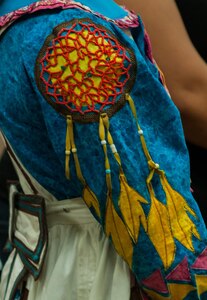 The details sewn in the dresses worn by members of the Lumbee nation have a specific meaning for each person. Three members of the Lumbee Tribe of North Carolina shared their history and heritage during the U.S. Army Forces Command and U.S. Army Reserve Command National American Indian Heritage event, hosted by both command's Equal Opportunity directorates, at the U.S. Army Forces Command and U.S. Army Reserve Command headquarters, Nov. 18, 2015. The event recognized the tribe's contributions to America and the nation's history. (U.S. Army photo by Timothy L. Hale/Released)