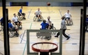 Members of the 10th Expeditionary Airlift Evacuation Flight and 721st Aircraft Maintenance Squadron tip off during a Wounded Warrior Basketball game Nov. 13, 2015, at Ramstein Air Base, Germany. The Warrior Transition Battalion hosted the tournament to show Airmen how wounded service members stay resilient through their recovery. (U.S. Air Force photo/Staff Sgt. Armando A. Schwier-Morales)