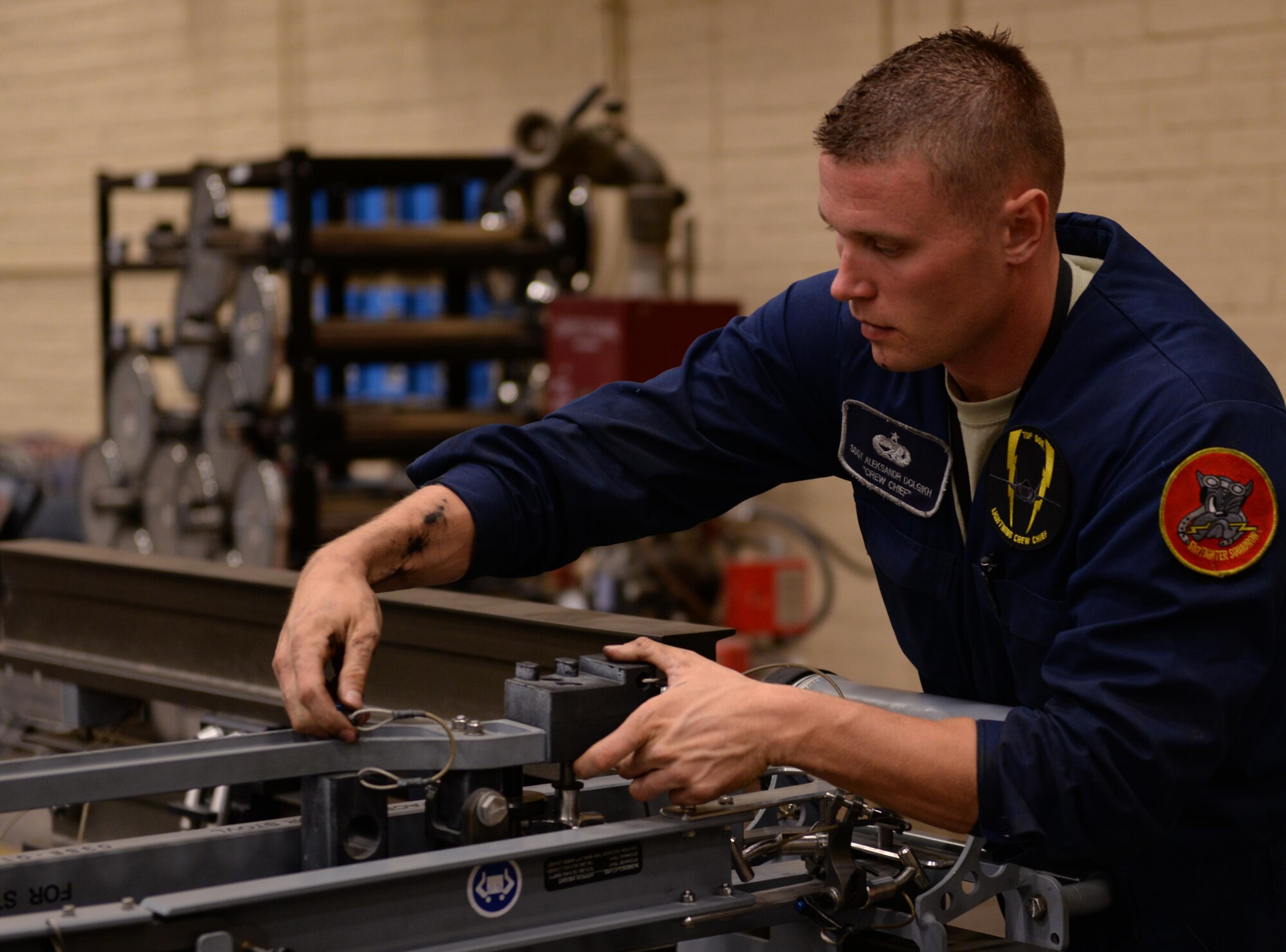 Staff Sgt. Aleksandr Dolgikh, 61st Aircraft Maintenance Unit crew chief, works with equipment designed to help disassemble F-35 Lightning II components. The 61st AMU works in conjunction with Detachment 12, 372nd Training Squadron to train Hill Air Force Base, Utah, maintainers who are sent here to learn the skills necessary to maintain F-35s. 