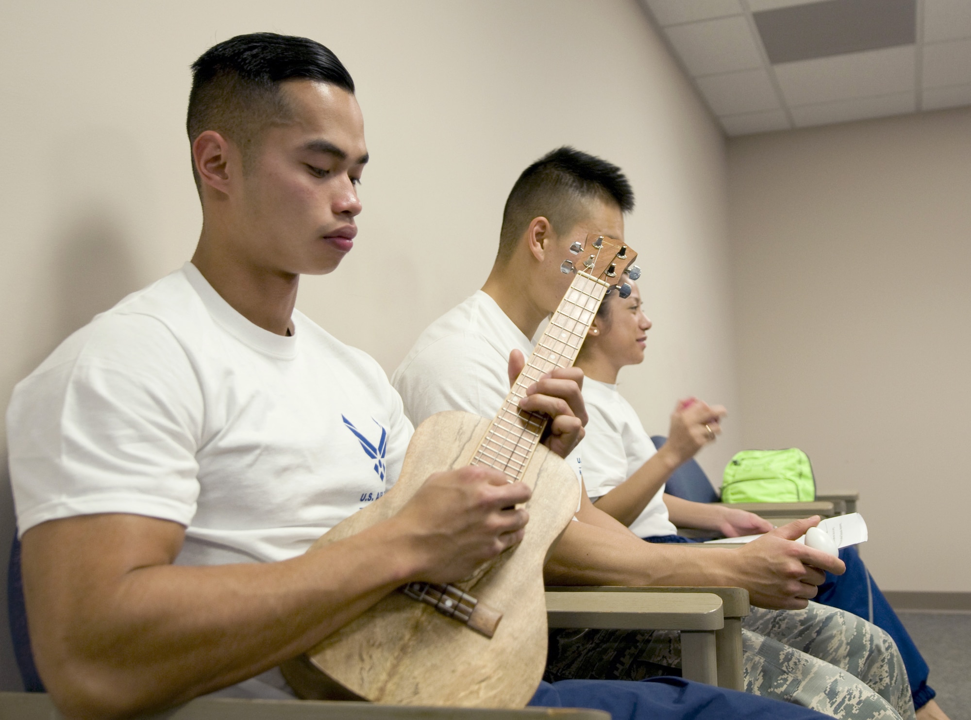 Senior Airman Daryl Jose strums a ukulele during a music therapy session Nov. 19, 2015, on Joint Base Andrews, Md., as part of Warrior CARE Month. Airmen had the chance to use a variety of musical instruments and collaborate on songs in the sessions, which were intended to show wounded warriors a unique approach to therapy. (U.S. Air Force photo/Sean Kimmons)