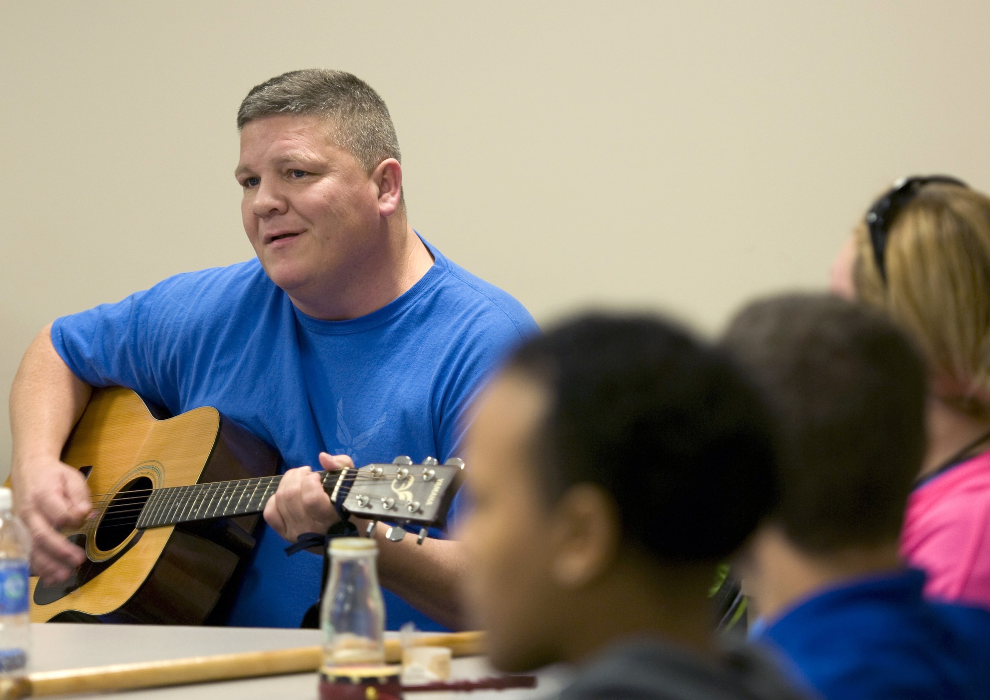Former Maj. Frank Vassar plays one of his songs to fellow wounded Airmen during a music therapy session Nov. 19, 2015, on Joint Base Andrews, Md., as part of Warrior CARE Month. Airmen had the chance to use a variety of musical instruments and collaborate on songs in the sessions, which were intended to show wounded warriors a unique approach to therapy. (U.S. Air Force photo/Sean Kimmons)