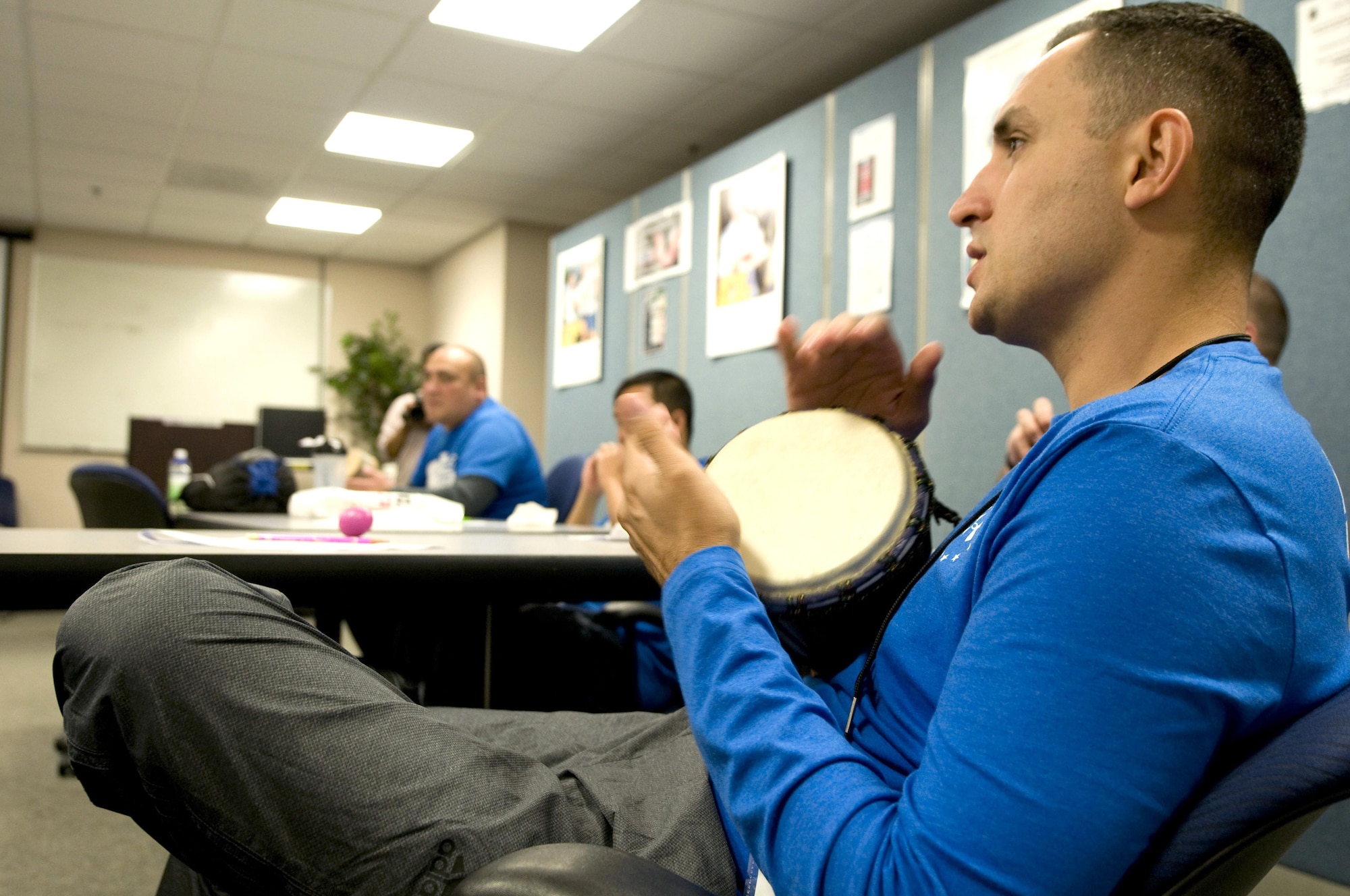 First Sgt. Estevan Vigil taps a bongo as he sings along with other wounded Airmen during a music therapy session Nov. 19, 2015, on Joint Base Andrews, Md., as part of Warrior CARE Month. Airmen had the chance to use a variety of musical instruments and collaborate on songs in the sessions, which were intended to show wounded warriors a unique approach to therapy. (U.S. Air Force photo/Sean Kimmons)