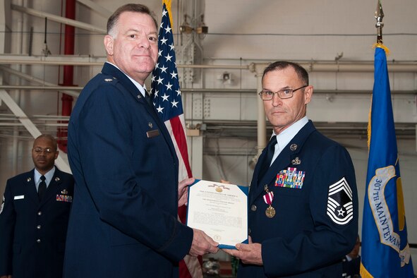 U.S. Air Force Lt. Col. Leo Kamphaus, 307th Maintenance Group commander, presents the Meritorious Service Medal to Chief Master Sgt. Vernon Cox during a Commander’s Call on Nov. 8, 2015, Barksdale Air Force Base, La. Cox received the medal for outstanding service to the United States while assigned as the Quality Assurance Superintendent for the 307th Maintenance Group from July 29, 2012 to Sept. 20, 2015. (U.S. Air Force photo by Master Sgt. Greg Steele/Released)