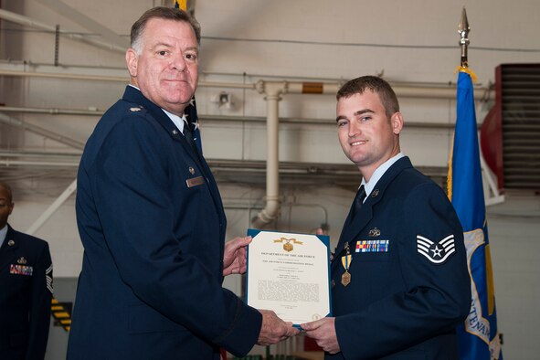 U.S. Air Force Lt. Col. Leo Kamphaus, 307th Maintenance Group (MXG) commander, presents the Air Force Commendation Medal to Staff Sgt. Bradley Austin during a Commander’s Call on Nov. 8, 2015, Barksdale Air Force Base, La. Austin received the medal for distinguished meritorious service while assigned to the 307th Aircraft Maintenance Squadron, 307th MXG, 307th Bomb Wing, from April 8, 2009 to April 7, 2014. (U.S. Air Force photo by Master Sgt. Greg Steele/Released)