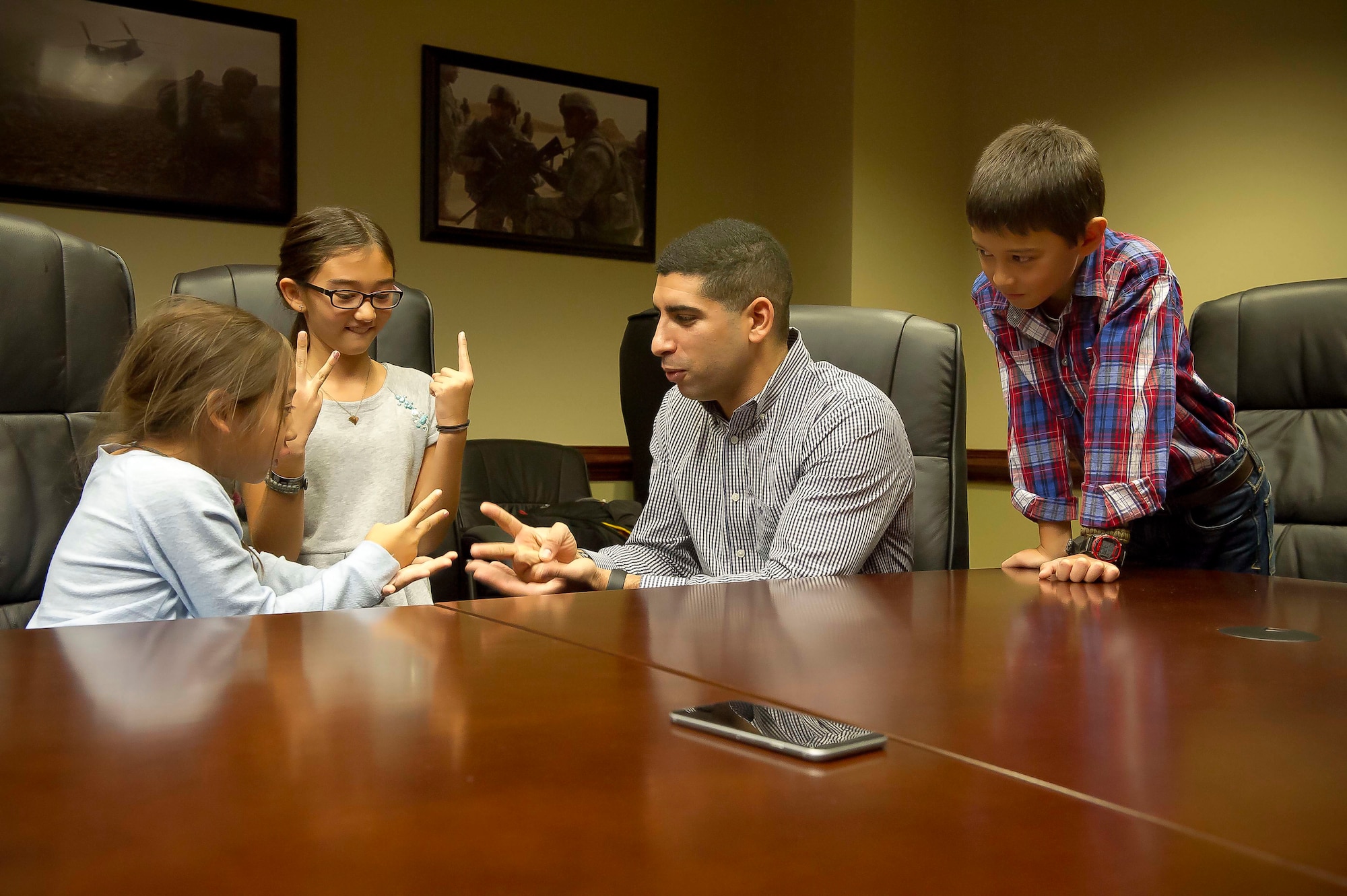 Retired Army Capt. Florent Groberg, a Medal of Honor recipient, plays rock-paper-scissors with Ava Gray, as her sister, Nyah, keeps score and her brother, Garrett, watches inside the Pentagon in Washington, D.C., Nov. 9, 2015. Groberg was with Maj. David Gray, the children’s father, when he was killed in action Aug. 8, 2012, during a deployment to Afghanistan. The family was together at the Pentagon for a Flag for Hope event. (U.S. Air Force photo/Staff Sgt. Christopher Gross)