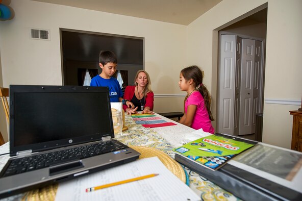 Heather Gray (middle) goes over how to properly conduct an experiment with her children Garrett, 9, and Ava, 7, during a home school session Nov. 10, 2015, at a friend’s house in Virginia. Heather started home schooling her children at the start of this school year. Heather and her three children moved from Colorado, where her husband David was stationed at Fort Carson, earlier this year for the first time since his death. (U.S. Air Force photo/Staff Sgt. Christopher Gross)
