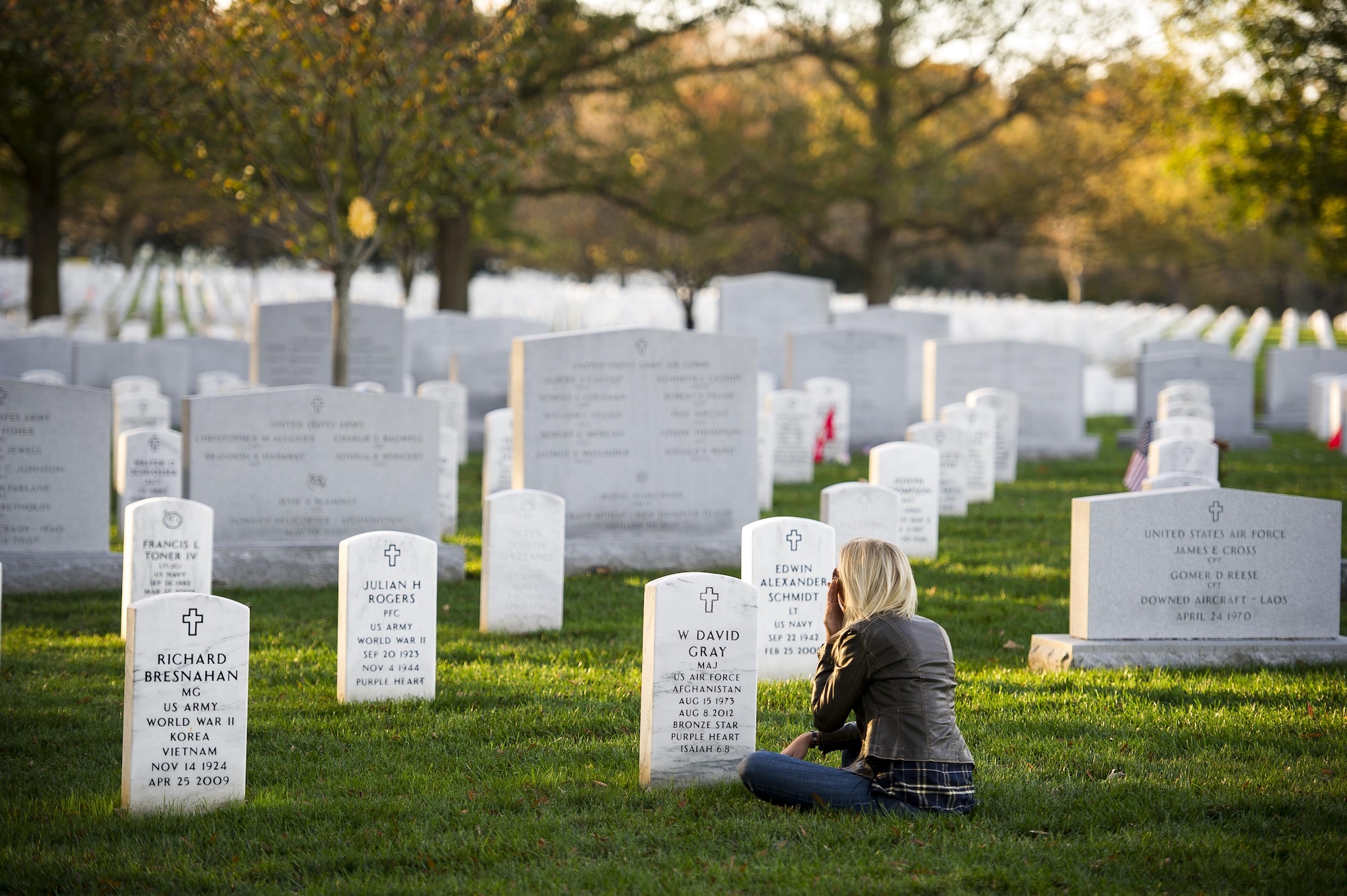 Heather Gray sits in front of the headstone for her husband, Maj. David Gray, at Arlington National Cemetery, Va., Nov. 11, 2015. Her husband was killed in action Aug. 8, 2012, during a deployment to Afghanistan. Heather and her three children moved from Colorado, where David was stationed at Fort Carson, earlier this year for the first time since his death. (U.S. Air Force photo/Staff Sgt. Christopher Gross)
