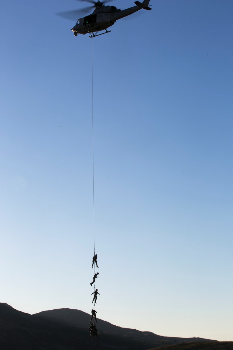 U.S. Marines with Golf Co., Battalion Landing Team 2/1, 13th Marine Expeditionary Unit (MEU), are lifted in the air for flight during Special Patrol Insertion and Extraction (SPIE) rigging training at Camp Pendleton, Calif., Nov. 19, 2015. SPIE rigging training prepares Marines for fast entry and exit from difficult and possibly dangerous combat areas. (U.S. Marine Corps photo by Cpl. Briauna Birl/RELEASED)