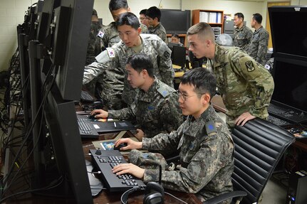 Korean Augmentee to the U.S. Army Cpl. Seungsu Nam, a human resources specialist and Pfc. Jacob Porter, a network switching system operator, assigned to Headquarters Battery, 6-52 Air Defense Artillery Battalion, work with Republic of Korea Air Force air and missile defenders from 177th ADA Battalion to respond to a simulated air battle during the unit’s combined interoperability exercise held Nov. 17-18, 2015, at Suwon Air Base.
