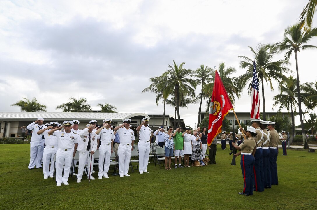 The U.S. Marine Corps Forces, Pacific Color Guard, along with service members and visitors, render honors during the National Anthem at Pearl Harbor Colors, Honors and Heritage Ceremony at the World War II Valor in the Pacific National Monument, Hawaii, Nov. 19, 2015. The ceremony is held once a month to honor the sacrifices of our armed forces, both those serving now and those have served.