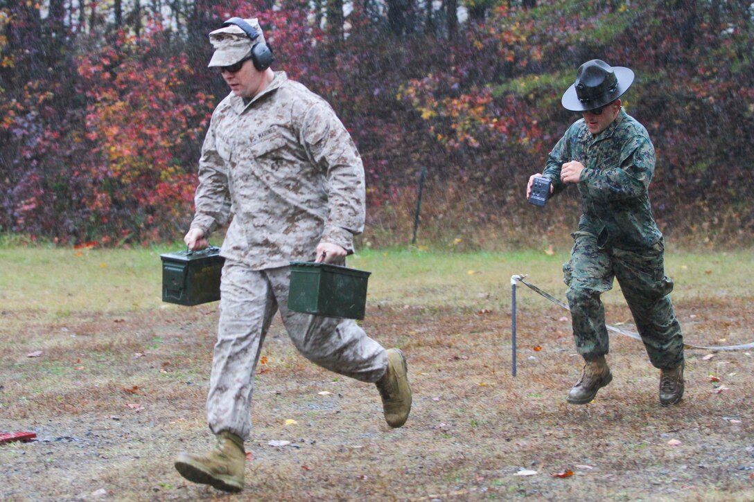 Maj. Peter McGrath, Manpower and Reserve Affairs, and Staff Sgt. James Fehr, Weapons Training Battalion range officer, compete in the fifth annual Combat Shooting Competition Oct. 28, hosted by Weapons Training Battalion aboard Marine Corps Base Quantico.