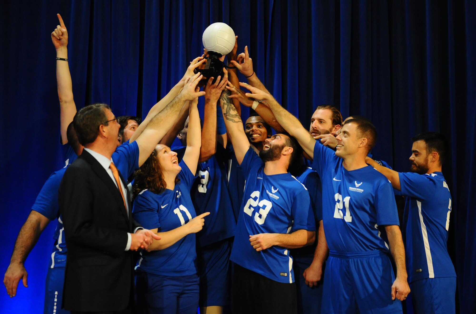 The Air Force Wounded Warrior Team, along with Defense Secretary Ash Carter, raise the coveted 1st place trophy after winning the Warrior Care Month Sitting Volleyball Tournament at the Pentagon in Washington, D.C., Nov. 19, 2015. The Air Force team edged out the Marines in the final match. (U.S. Air Force photo/Senior Airman Hailey Haux)  