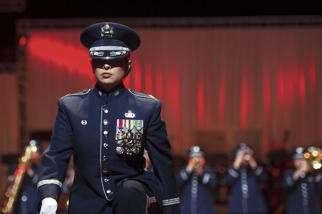 U.S. Air Force Maj. Cristina Moore Urrutia, commander and conductor of the U.S. Air Force Band of the Pacific, walks to a podium to deliver remarks during the Japan Self-Defense Force Marching Festival in Tokyo, Nov. 13, 2015. Urrutia spoke about the relationship between the two countries during the 70 years since the end of World War II. U.S. Air Force photo by Airman 1st Class Delano Scott