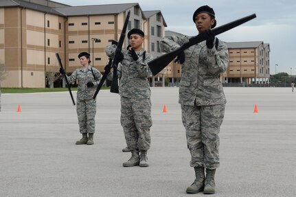 A drill team representing the 937th Training Group performs drill maneuvers during a drill competition between Joint Base San Antonio tech. schools Nov. 13, 2015, at JBSA-Lackland, Texas. The team won third place against two other teams who represented 344th and 343rd Training Squadrons. (U.S. Air Force photo by Senior Airman Krystal Wright/Released)