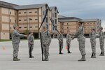 A drill team representing the 344th Training Squadron performs drill maneuvers during a drill competition between Joint Base San Antonio tech. schools Nov. 13, 2015, at JBSA-Lackland, Texas. The team won second place against two other teams who represented 343rd TRS and 937th Training Group. (U.S. Air Force photo by Senior Airman Krystal Wright/Released)