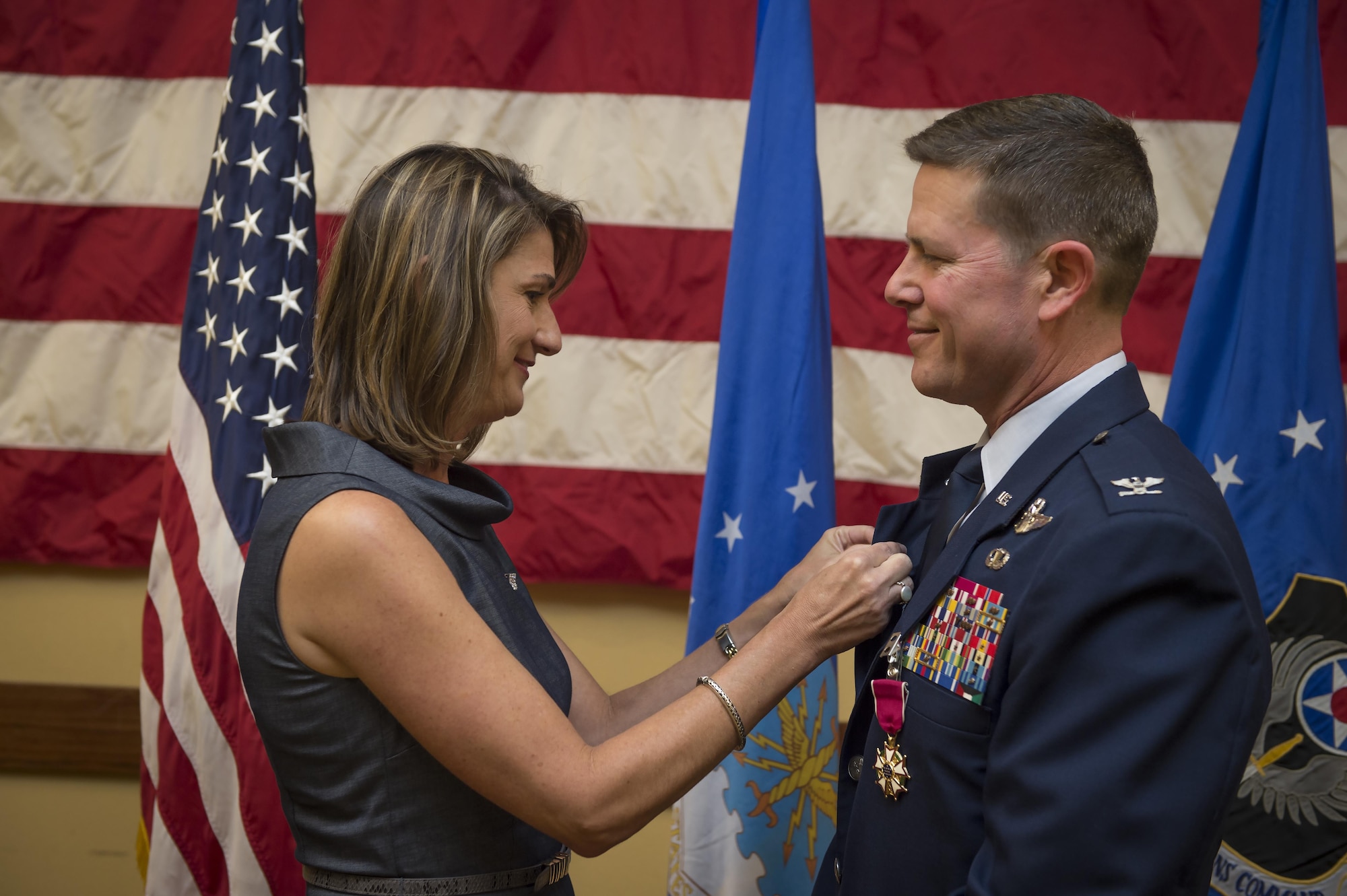 Col. Ted Corallo, Air Force Special Operations Command chief of staff, receives his retirement pin from his wife Jamee, during his retirement at the Soundside Club, on Hurlburt Field, Fla., Nov. 20, 2015. Corallo graduated from the U.S. Air Force Academy in 1989 and went on to undergraduate pilot training at Columbus Air Force Base, Miss. He served as the AFSOC chief of staff for the last 18 months. (U.S. Air Force photo by Senior Airman Christopher Callaway)