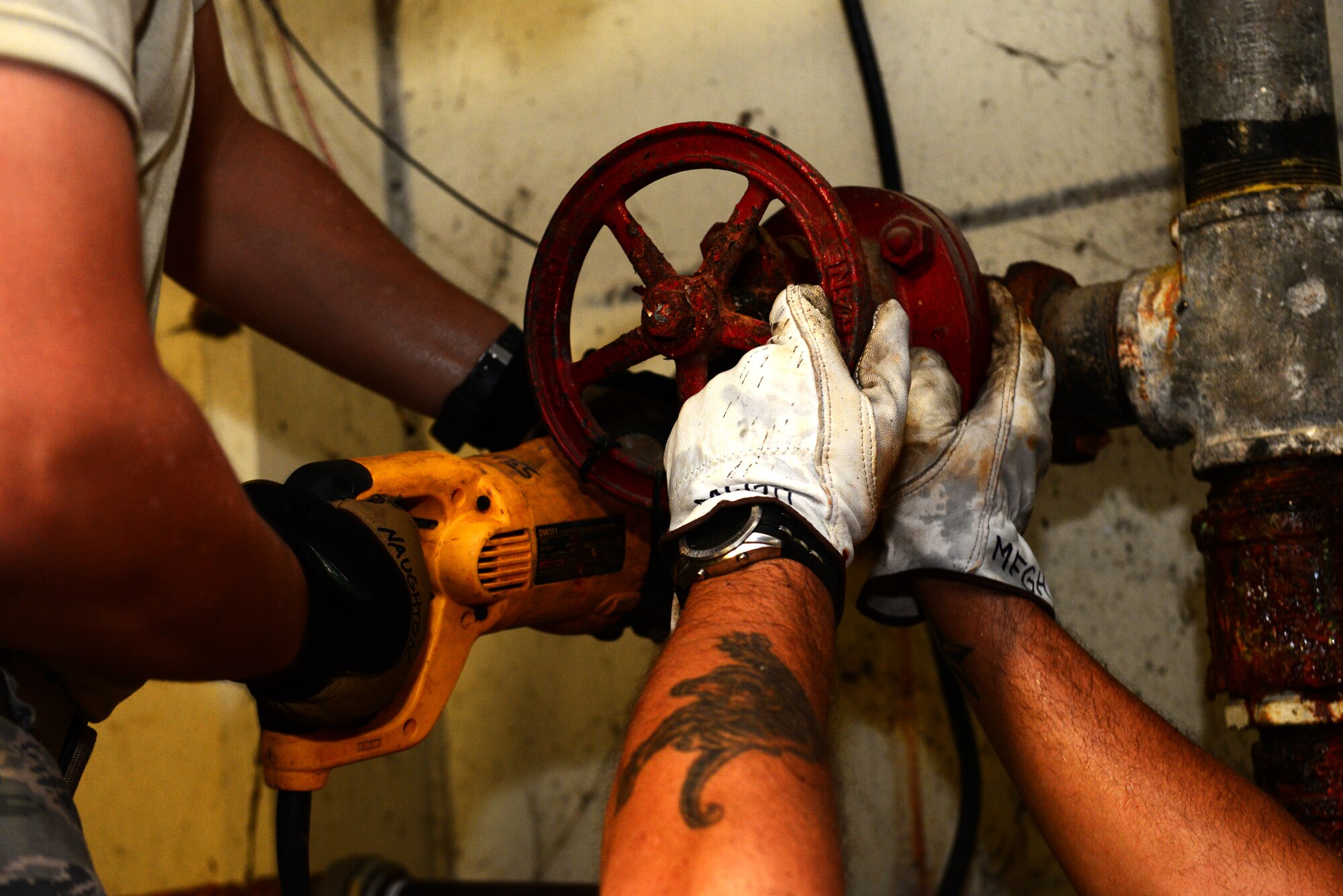 Airman 1st Class Michael Naughton, 2nd Civil Engineer Squadron water and fuel systems apprentice, left, and Glenn Hannis, 2nd CES water and fuel systems plumber, remove old piping from a water service line at Barksdale Air Force Base, La., Nov. 17, 2015. The service line provides water to an entire building including water used by heating, ventilation and air conditioning systems and fire systems. (U.S. Air Force Photo/Airman 1st Class Luke Hill)