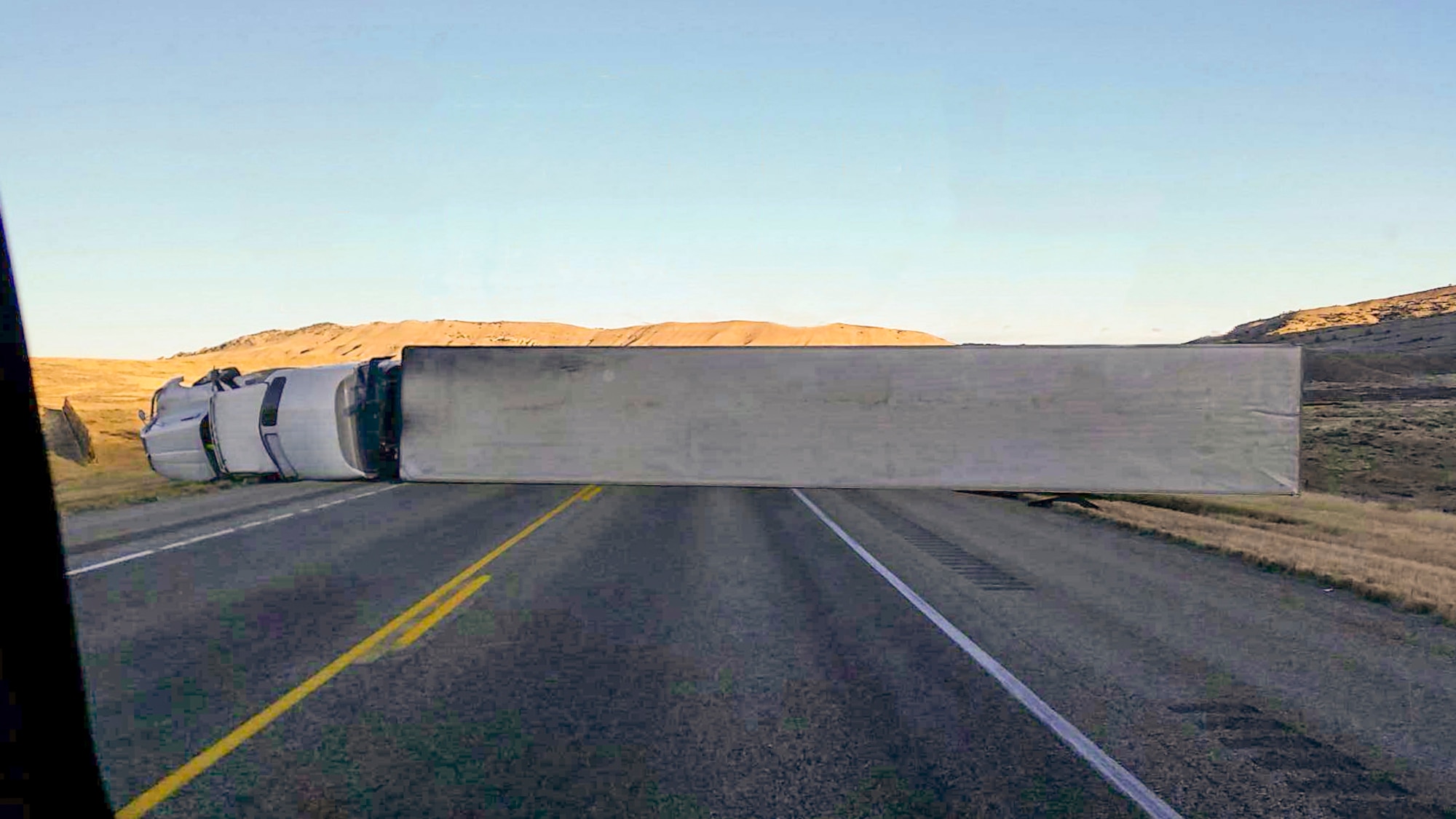 An 18-wheeler lies on its side perpendicular to U.S. Route 287 in central Wyoming Nov. 18, 2015. Airmen in a 90th Missile Wing Honor Guard detail were the first responders on scene. (Courtesy photo)
