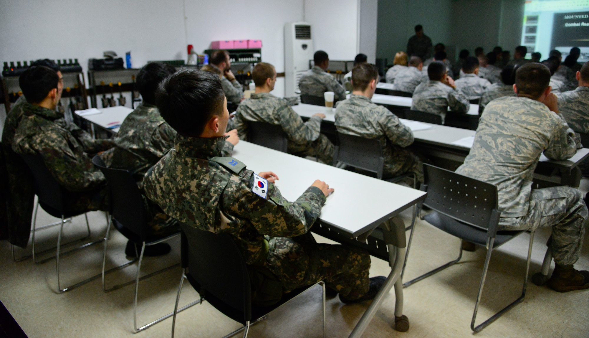 The 51st Security Forces Squadron defenders and Republic of Korea airmen are briefed during the combat readiness course on Osan Air Base, ROK, Nov. 17, 2015. The five-day course covers different spectrums of defense needed to support the mission such as non-lethal fighting, combatives, land navigation and active-shooter training. (U.S. Air Force photo/Senior Airman Kristin High)