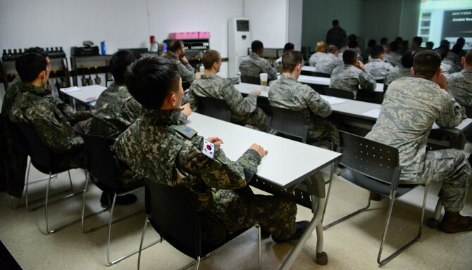 The 51st Security Forces Squadron defenders and Republic of Korea airmen are briefed during the combat readiness course on Osan Air Base, ROK, Nov. 17, 2015. The five-day course covers different spectrums of defense needed to support the mission such as non-lethal fighting, combatives, land navigation and active-shooter training. (U.S. Air Force photo/Senior Airman Kristin High)