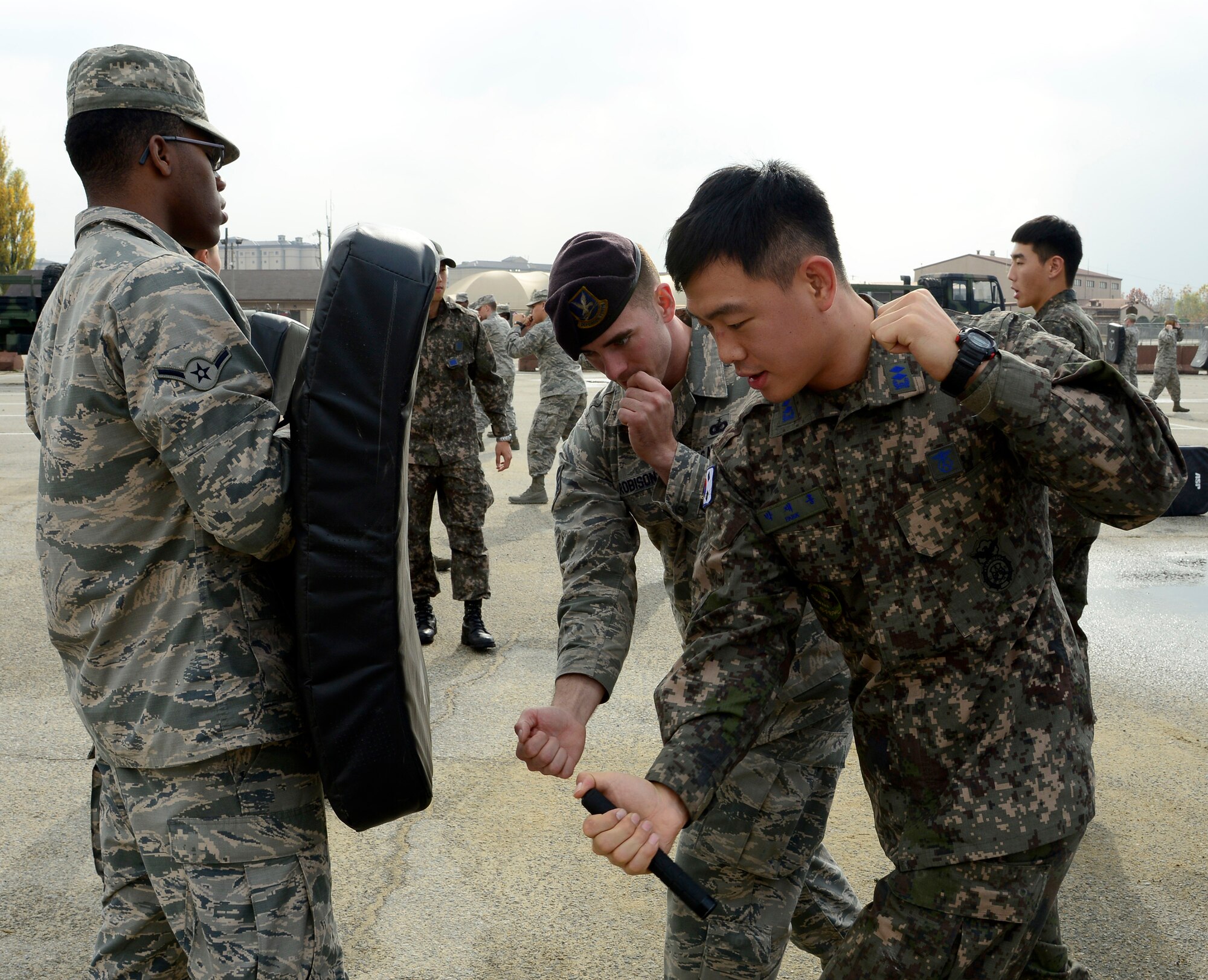 Staff Sgt. Aaron Robison, 51st Security Forces Squadron training instructor, teaches 1st Lt. James Park, Republic of Korea air force 3rd Training Wing special duty team, proper baton training during the combat readiness course on Osan Air Base, ROK, Nov. 17, 2015. The five-day course covers different spectrums of defense needed to support the mission such as non-lethal fighting, combatives, land navigation and active-shooter training. It is designed to teach or re-teach the defenders to perform communicative, tactical, and emergency procedures through simulated environments ensuring they're prepared for real-world contingencies. (U.S. Air Force photo/Senior Airman Kristin High)