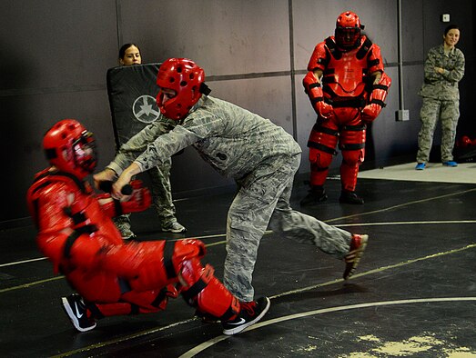 A 51st Security Forces Squadron defender pushes a “Redman” during the combat readiness course on Osan Air Base, Republic of Korea, Nov. 17, 2015. The Redman or red man suit is a full-body protective suit for instructors or volunteers to wear for protection during baton training. Redman training creates a realistic environment giving Airmen necessary hands-on experience to be able to take on someone who may be inebriated or overly aggressive. (U.S. Air Force photo/Senior Airman Kristin High)