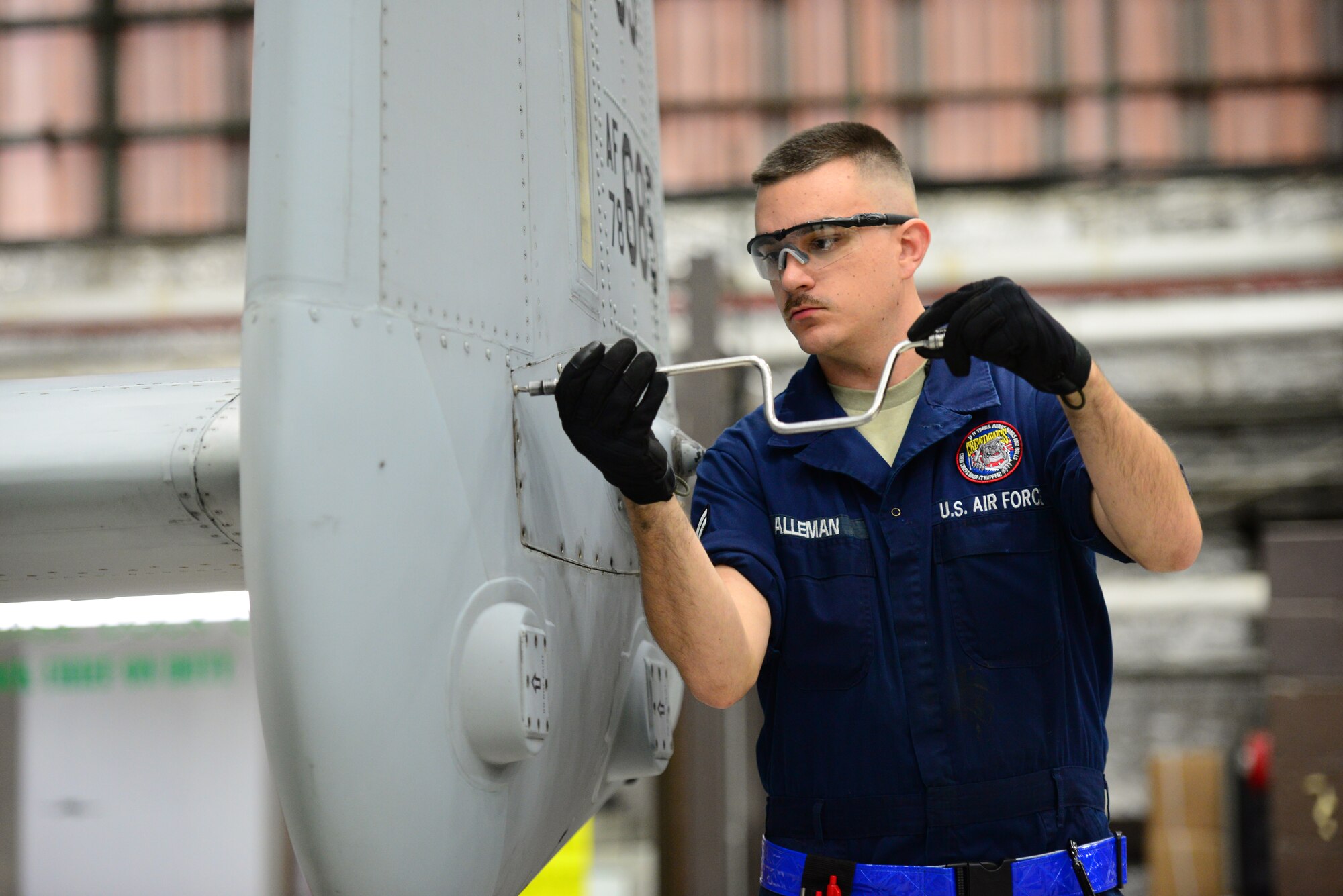 Airman 1st Class Cody Alleman, 51st Maintenance Squadron phase dock crew chief, remove screws from a tail panel on an A-10 Thunderbolt II during a routine phase inspection at Osan Air Base, Republic of Korea, Nov. 16, 2015. Panel removal is the first step in the in-depth inspection and preventive maintenance regiment the airframe must undergo after every 500 flight hours. (U.S. Air Force photo/Staff Sgt. Amber Grimm)