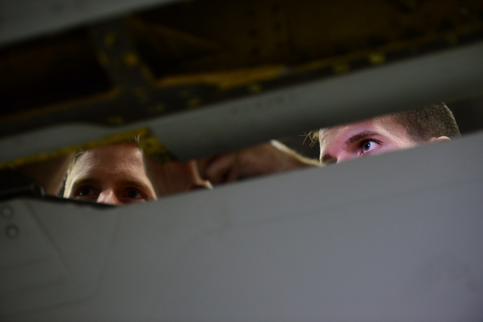 Senior Airmen Justin Frazier and Nathan Phillips, 51st Maintenance Squadron aerospace recovery specialists, perform routine maintenance on the wing of an A-10 Thunderbolt II at Osan Air Base, Republic of Korea, Nov. 16, 2015. The maintenance is part of the in-depth phase inspection preformed on the airframe after every 500 hours of flight time. (U.S. Air Force photo/Staff Sgt. Amber Grimm)