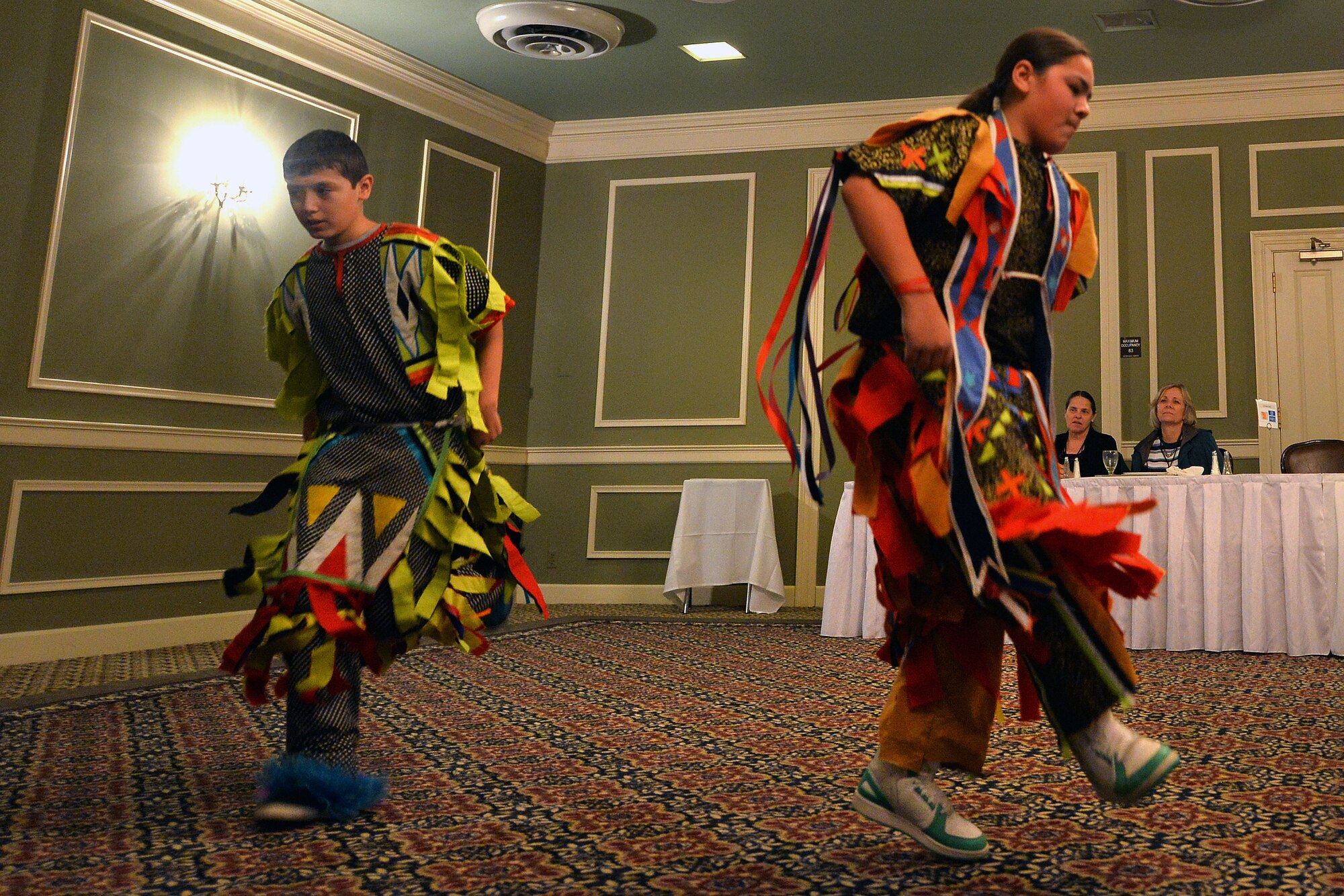 Diego Gill, left, and Carlos Sandoval perform the Men’s Grass dance Nov. 18, 2015, during the Native American Heritage Month Cultural Information Fair and Expo at the Patriot Club, Offutt Air Force Base, Neb. The dance was traditionally performed to flatten the grass and make room for other dances. (U.S. Air Force photo by Josh Plueger)