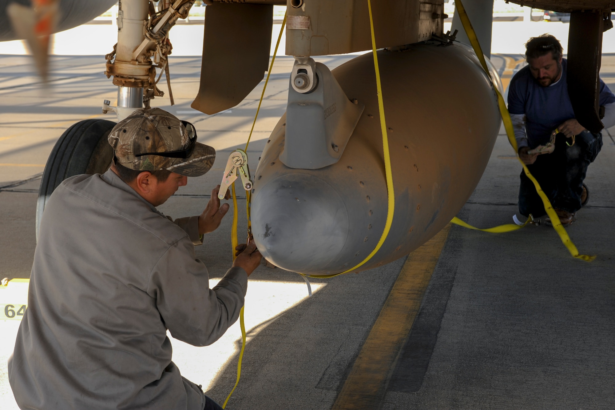 David Williamson, chief project manager, and Tony Martinez, crane mechanic, remove a fuel tank from an F-15A Eagle on the flightline at Davis-Monthan Air Force Base, Ariz., Nov. 17, 2015. Williamson will travel to Joint Base Lewis-McChord, Wash., to complete the project of reassembling the F-15A Eagle and putting it on display. The entire project is estimated to take approximately eight months from the planning stage to finish. (U.S. Air Force photo by Airman Basic Nathan H. Barbour/Released)